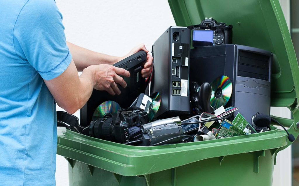 Man disposing electronics including an old TV