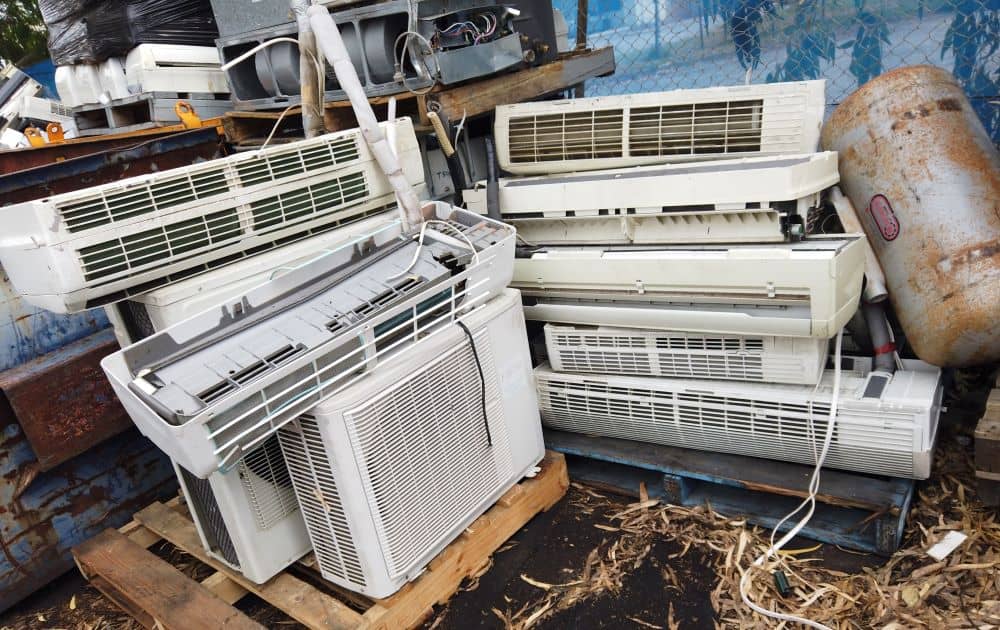 Air conditioning recycling centre with aircons on the ground